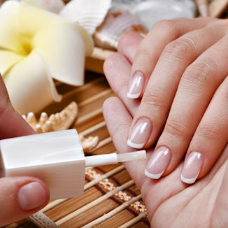 applying a layer of base coat to nails